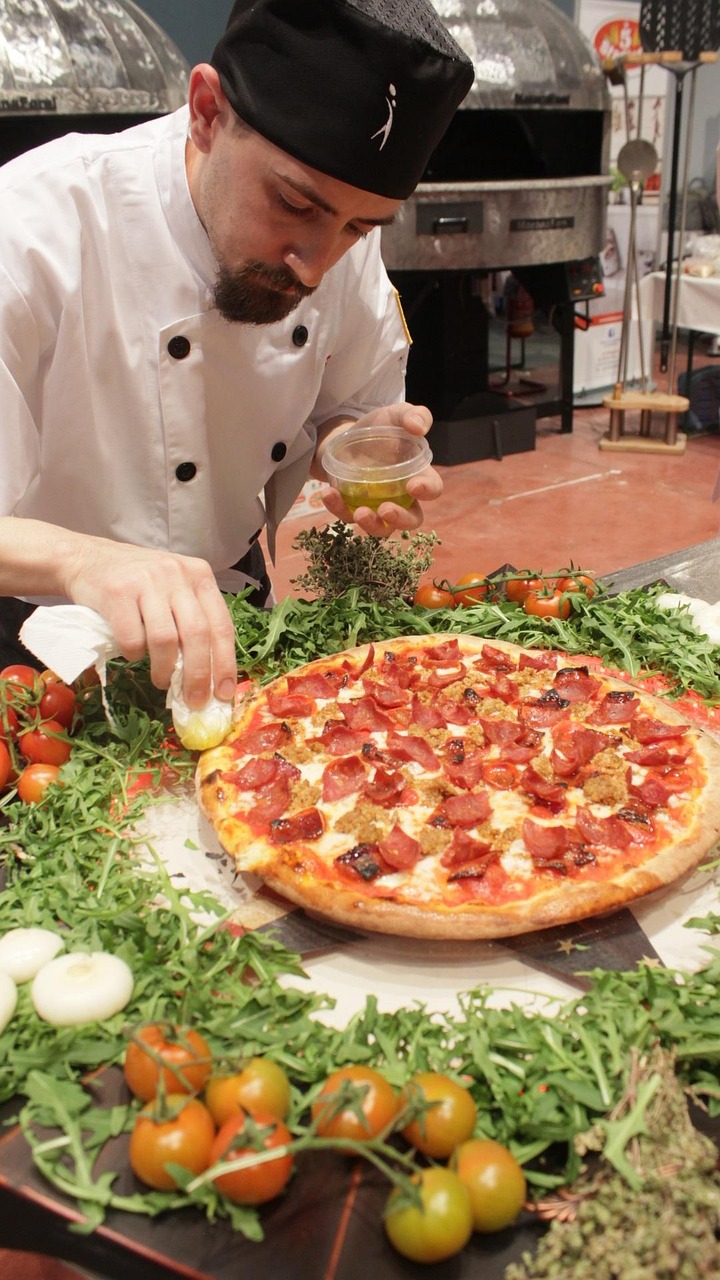 A close-up shot shows a slice of pizza being pulled from a whole pizza, with melted cheese stretching between them.
